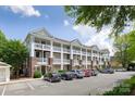 Multi-story apartment building with private balconies and ample parking in front at 795 Peninsula Dr, Davidson, NC 28036