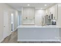 Open-concept kitchen featuring stainless steel appliances, modern finishes, and bright countertops at 795 Peninsula Dr, Davidson, NC 28036