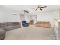 Spacious living room with three ceiling fans, neutral carpeting, and comfortable sofas at 80 Lecline Ne Cir, Concord, NC 28025