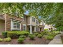 Attractive townhome exterior showcasing a mix of stone and siding, complemented by lush, green landscaping at 8232 Sunset Hill Rd # Th88, Waxhaw, NC 28173