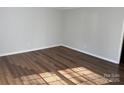 Bright bedroom featuring new wood-look flooring, crown molding, and fresh paint at 824 6Th Nw St # 5, Hickory, NC 28601