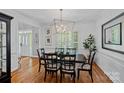 Stylish dining room featuring hardwood floors, plantation shutters, and a modern lighting fixture at 9427 Gilpatrick Ln # 5, Huntersville, NC 28078
