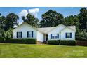 Inviting single-story house with white siding, blue shutters, and green lawn at 958 Hillard Ln, Lincolnton, NC 28092