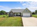 Beautiful single-Gathering home featuring a lush lawn, a driveway to the two car garage, and a welcoming facade at 100 Royal Ave, Albemarle, NC 28001