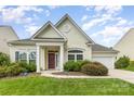Charming single-story home featuring a well-manicured lawn, inviting entrance, and attached garage at 1116 Arnott Ln, Matthews, NC 28105