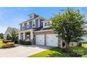 Attractive two-story home with gray siding, stone accents, two-car garage and well-maintained landscaping at 11317 Fullerton Place Nw Dr, Huntersville, NC 28078