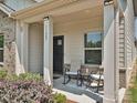 Inviting covered front porch featuring a seating area, perfect for enjoying the outdoors at 11807 Midnight Way, Huntersville, NC 28078