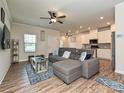 Open-concept living room with hardwood floors seamlessly connecting to the modern kitchen at 11807 Midnight Way, Huntersville, NC 28078