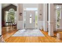 Bright foyer with hardwood floors, paneled walls and a white front door with sidelights at 13101 Kensworth Ct, Charlotte, NC 28277