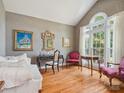 Cozy living room with hardwood floors, vaulted ceiling and large windows providing natural light at 13101 Kensworth Ct, Charlotte, NC 28277