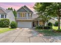 Charming two-story home with a two-car garage, brick accents, and well-manicured landscaping at 13510 Brandon Trail Dr, Charlotte, NC 28213