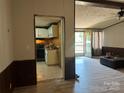 View of the living room leading into the adjacent kitchen, with wood-look floors at 1355 Oak Breeze Dr, Mooresville, NC 28115
