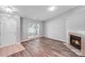 Inviting living room with light gray walls, wood-look flooring and cozy fireplace at 1703 Southwind Dr, Charlotte, NC 28216
