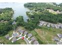 Expansive aerial view of homes nestled amongst lush green trees, neighborhood streets, and waterfront views of Lake Norman at 17718 Terryglass Ln, Charlotte, NC 28278