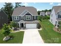 A charming two-story home featuring a well-manicured lawn, a two-car garage, and complementary landscaping at 17718 Terryglass Ln, Charlotte, NC 28278