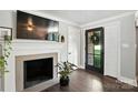 Stylish entryway featuring a stone fireplace, a mounted TV, and a glass-paneled door at 188 Gum Branch Rd # 3, Charlotte, NC 28214