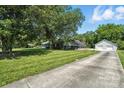 Home with a large, tree-filled yard and a detached two-car garage with a long driveway at 188 Gum Branch Rd # 3, Charlotte, NC 28214