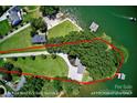 Aerial view showcasing the home's wooded lot and private waterfront access, approximately 300' shoreline at 188 Ponderosa Cir, Mooresville, NC 28117