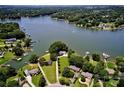 Stunning aerial view of lakefront home with lush landscaping and private dock, approximately 300' shoreline at 188 Ponderosa Cir, Mooresville, NC 28117