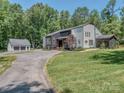Well-maintained home with a circular driveway, screened-in porch, and an additional detached garage at 202 Walden Ln, Weddington, NC 28104