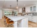 Spacious kitchen with island and seating overlooks the connected dining area at 202 Walden Ln, Weddington, NC 28104