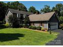Charming two-story home with attached garage and lush green lawn, perfect for outdoor enjoyment at 204 Brentwood Dr, Maiden, NC 28650