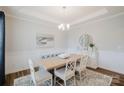 Elegant dining room with wainscoting, a modern chandelier, and ample natural light at 2296 Idol Rock Dr, Indian Land, SC 29707