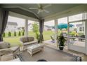 Relaxing screened-in porch with comfortable seating and view of the landscaped backyard at 2296 Idol Rock Dr, Indian Land, SC 29707