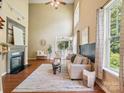 Inviting living room showcases soaring ceilings, natural light, and a cozy fireplace for relaxing evenings at 2545 Chasewater Dr, Fort Mill, SC 29707