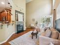 Inviting living room with hardwood floors, a cozy fireplace, and sliding glass doors to an outdoor space at 2545 Chasewater Dr, Fort Mill, SC 29707