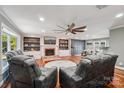 Spacious living room featuring a cozy fireplace, custom built-ins, and hardwood floors at 327 Johnson Dairy Rd, Mooresville, NC 28115