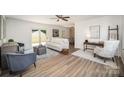 Open living room with wood floors and decoratively furnished seating areas at 3427 Wonderland Dr, Matthews, NC 28104