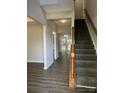 Bright foyer showcases a staircase with wood railing, neutral walls, and hardwood floors at 3617 Betterton Ln, Charlotte, NC 28269
