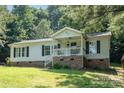 Charming single-Gathering home with a cozy front porch and well-maintained lawn at 394 Link Dr, Iron Station, NC 28080