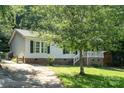 This single-Gathering home features a covered porch and convenient driveway at 394 Link Dr, Iron Station, NC 28080