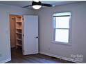 Bedroom with wood-look floors, closet with shelving, and a window at 412 E Taylor St, Landis, NC 28088
