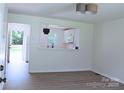 Bright, minimalist living room with wood floors and kitchen view at 412 E Taylor St, Landis, NC 28088