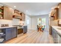 Well-lit kitchen featuring stainless steel appliances, modern countertops, stylish cabinets and a dining nook at 4226 Raney Way, Charlotte, NC 28205