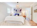 Bright and airy main bedroom with a plush king bed, and decorative lamps at 4226 Raney Way, Charlotte, NC 28205