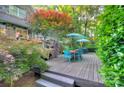 Spacious wooden deck with an outdoor dining area shaded by trees, great for gatherings at 4831 Antioch Church Rd, Matthews, NC 28104
