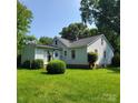 Rear view of a well-kept home with an expansive lawn and mature trees at 6908 Alexander Rd, Charlotte, NC 28270