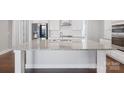 Bright, open kitchen featuring a large center island with granite countertops and modern appliances at 704 Kenway Loop, Mooresville, NC 28117