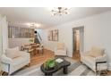 Spacious living room featuring hardwood floors, neutral decor, and a modern lighting fixture at 8025 Cliffside Dr, Charlotte, NC 28270