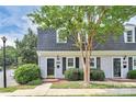 Inviting townhouse exterior with a well-kept lawn, shrubbery and charming architectural design at 8062 Knights Bridge Rd, Charlotte, NC 28210