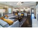 Open-concept living space with hardwood floors, a fireplace, and adjacent kitchen, perfect for entertaining at 1074 Wylie Falls Ln, York, SC 29745