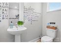 Whimsical half bathroom with unique wall decorations, sleek sink and toilet at 1113 Greenleaf Ave # A, Charlotte, NC 28202