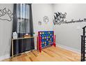 Bright bonus room with hardwood floors, playful decor, and ample natural light, ideal for recreation at 1113 Greenleaf Ave # B, Charlotte, NC 28202