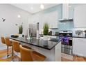 Modern kitchen featuring white cabinets, stainless steel appliances, and a large island with a black countertop at 1113 Greenleaf Ave # B, Charlotte, NC 28202