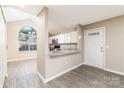 Kitchen featuring gray counters and flooring, white cabinets, and stainless steel appliances at 11531 Delores Ferguson Ln, Charlotte, NC 28277