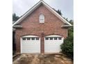 Beautiful brick home featuring a two-car garage with white doors at 1344 Moonshadow Ln, Shelby, NC 28150